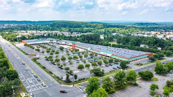 an aerial view of a parking lot with cars and trees