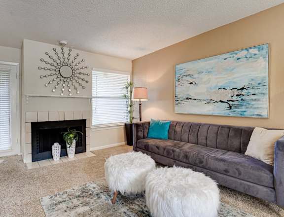 a living room with a couch and a fireplace