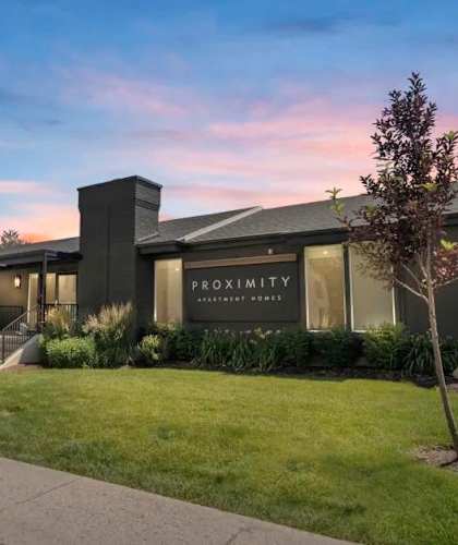 a building with a lawn and sidewalk in front of it