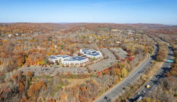 an aerial view of a building in the middle of a road