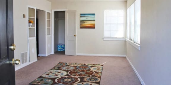 a living room with a carpet and a door that is open