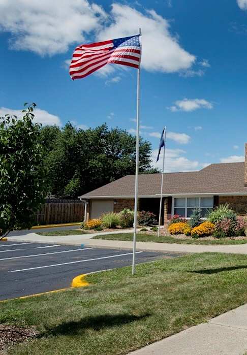 A building with a flag on a pole in front of it.