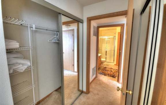a bathroom with a closet and a mirror in a closet