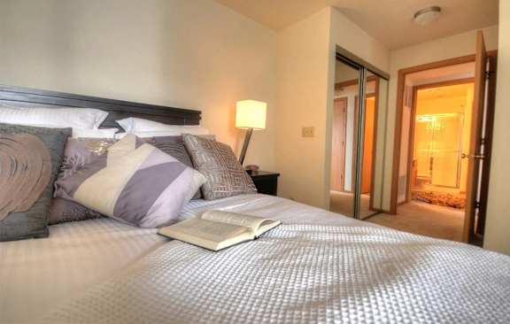 a bedroom with a bed with an open book on it