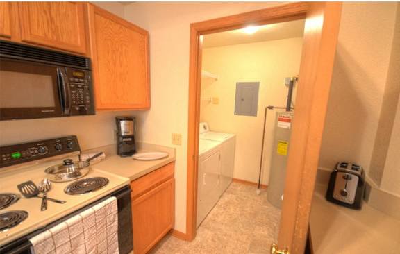 a kitchen with a stove and a refrigerator and a sink