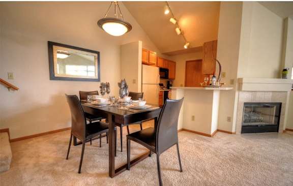 a dining room with a table and chairs and a fireplace