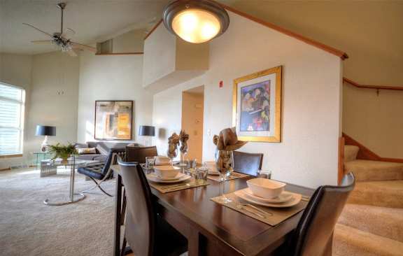 a dining room with a wooden table and chairs
