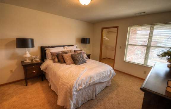 a bedroom with a large bed and a window