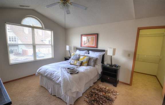 a bedroom with a large bed and a ceiling fan
