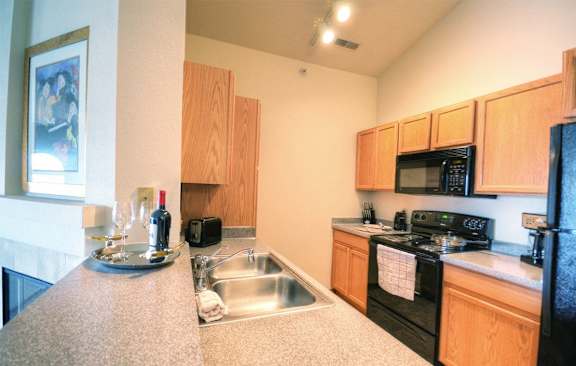 a kitchen with a sink and a stove and