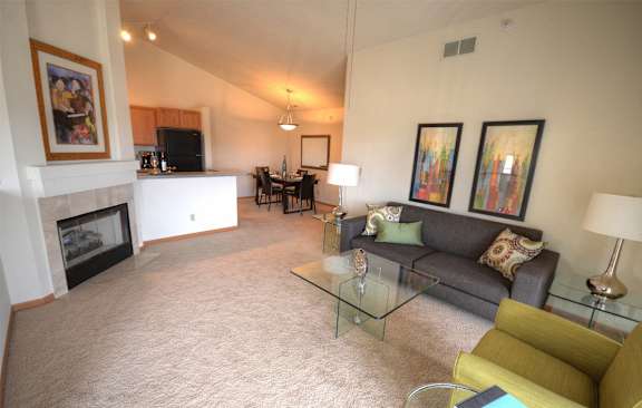 a living room with a couch and a table and a fireplace