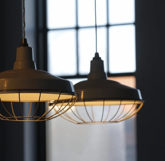 a couple of hanging lights in front of a window
