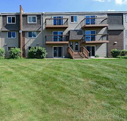 a large lawn in front of an apartment building