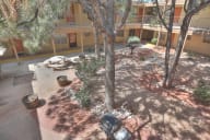 an aerial view of a courtyard with trees and tables