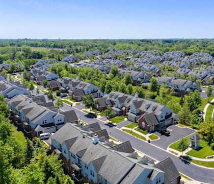 an aerial view of a neighborhood with rows of houses