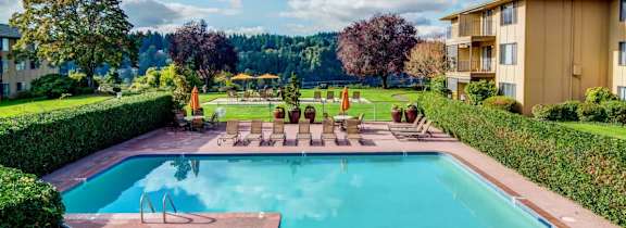 Swimming pool with chairs and a building in the background at Overlook at the Willamette, Milwaukie, 97222 ?