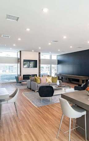 A modern dining room with a table set for six.