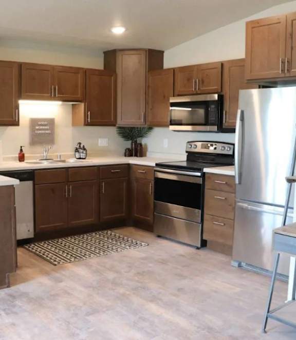 A kitchen with wooden cabinets and stainless steel appliances.