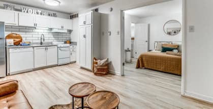 a living room with a kitchen and a bed