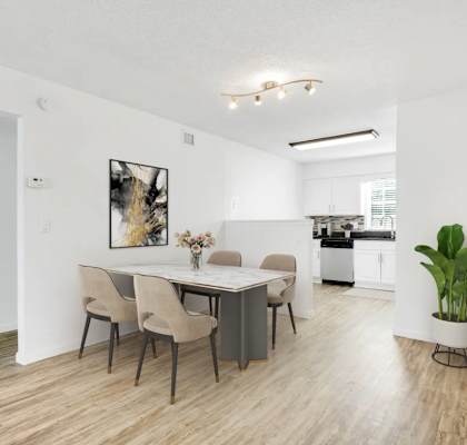 A dining room with a table and chairs.