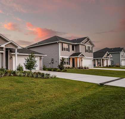 A modern house with a well-maintained lawn in front.