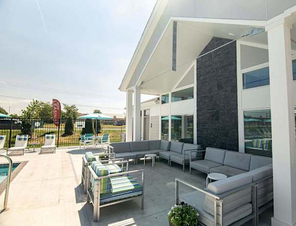 A patio with a pool table and chairs.