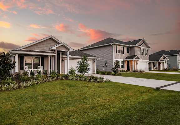 A modern house with a well-maintained lawn in front.