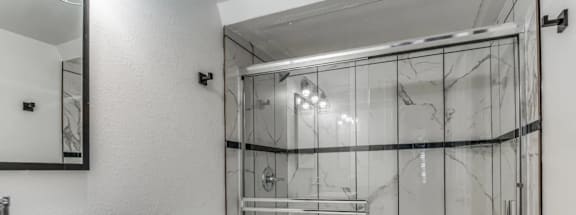 a bathroom with a shower and a sink and a toilet