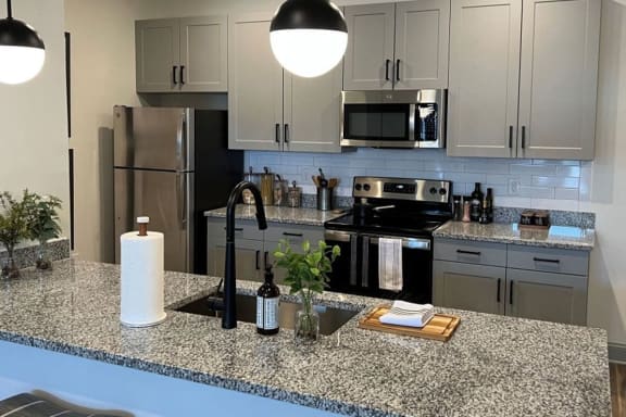 a kitchen with white cabinets and a counter top