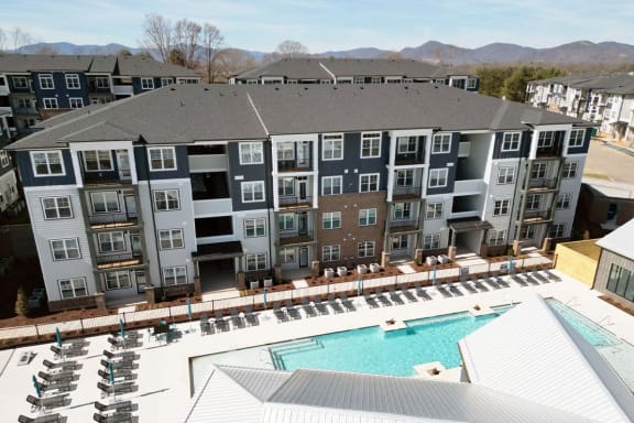 an aerial view of an apartment building with a swimming pool