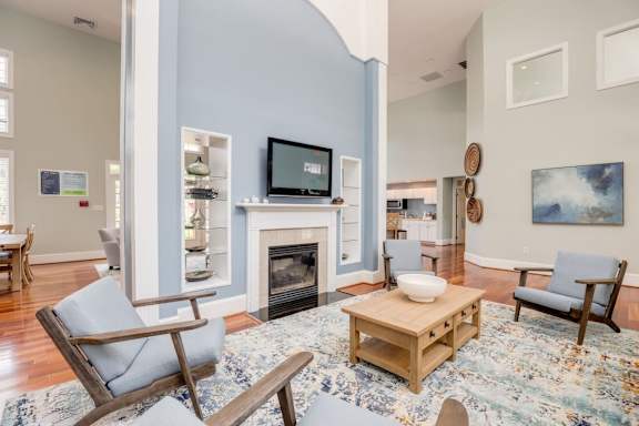 A living room with a fireplace and a television.