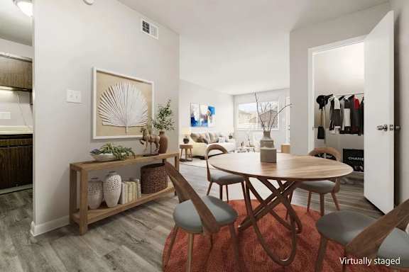 A modern dining room with a wooden table and chairs.