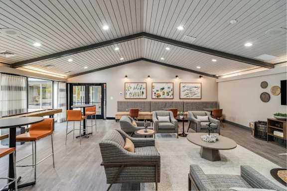 A spacious waiting area with a variety of seating options and artwork on the walls.