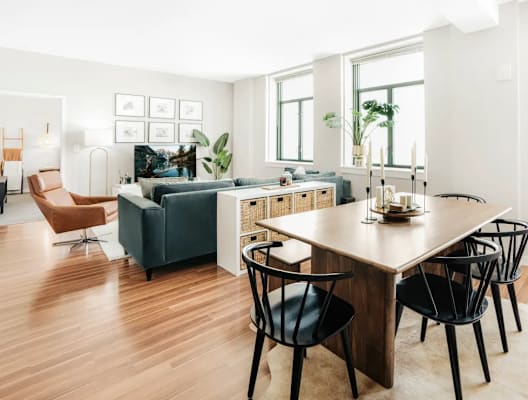 a living room and dining room with a table and chairs