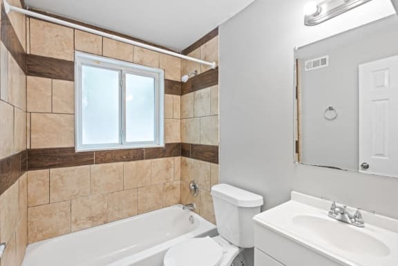 a bathroom with a sink toilet and a bath tub