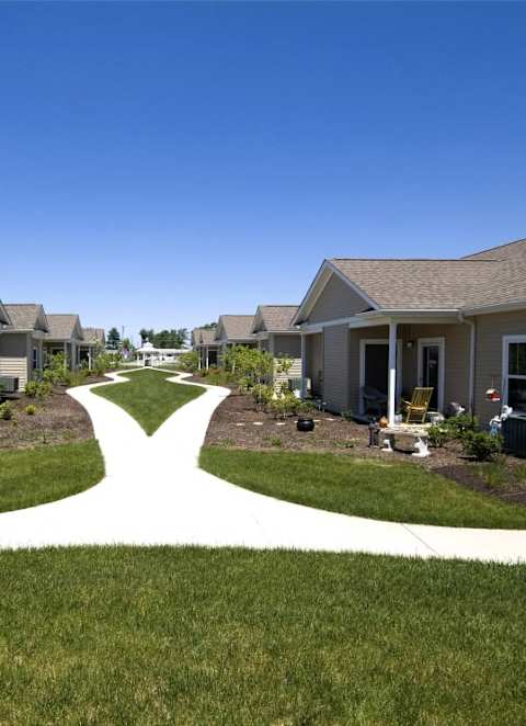 A row of houses with a pathway in the middle.