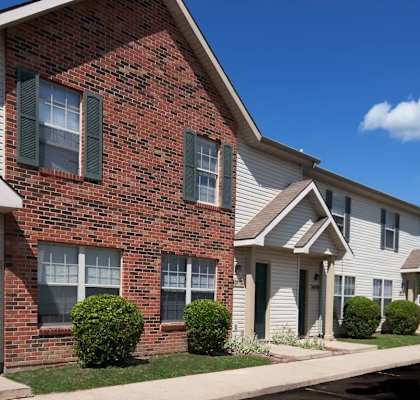 A row of houses with a blue sky in the background.