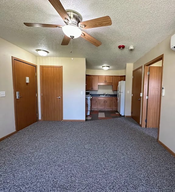 a living room and kitchen with a couch and a table