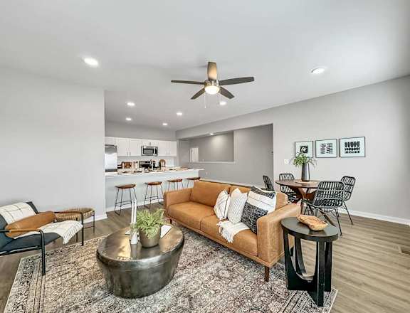 A living room with a brown couch and a coffee table.