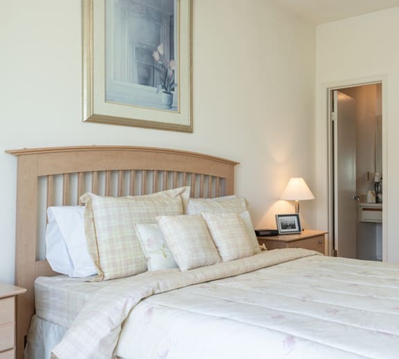 A comfortable sleeping space with soft lighting and plush carpeting.