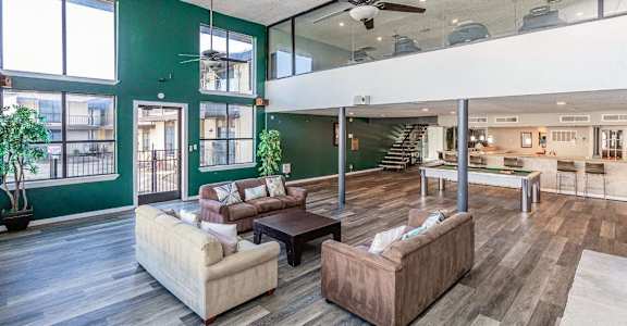 a large living room with furniture and a ceiling fan