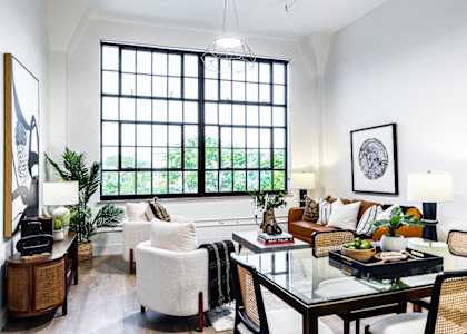 a living room filled with furniture and a large window
