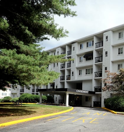 a large apartment building with cars parked in front of it