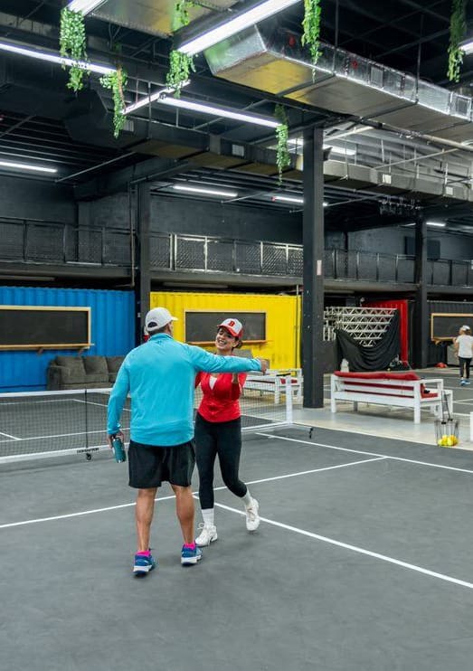 a group of people playing tennis on a tennis court