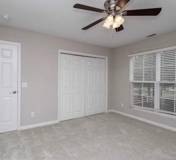 A room with a ceiling fan and two doors at Diamond Townhomes, Beaufort, South Carolina