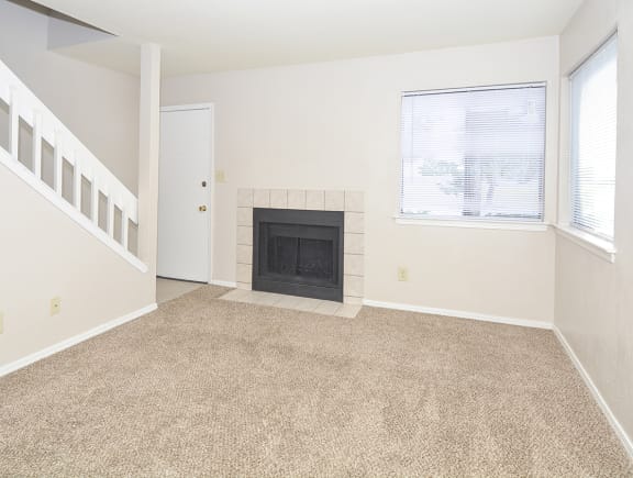 Carpeted Living Room with Fireplace and Large Double Windows