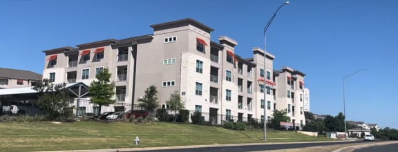 a building on a hill with a blue sky in the background