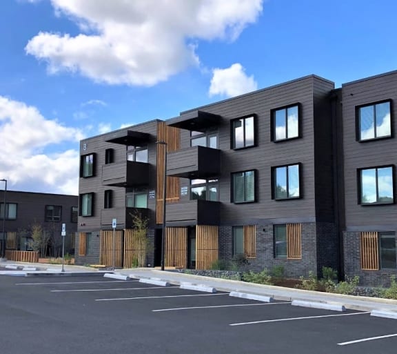 a row of new apartment buildings in a parking lot