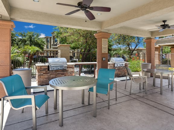 A patio with a table and chairs under a roof. at Superstition Canyon, Mesa, AZ, 85209