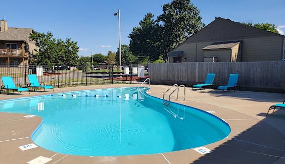 Willow Creek Apartments - Swimming pool with lounge chairs and clear water.